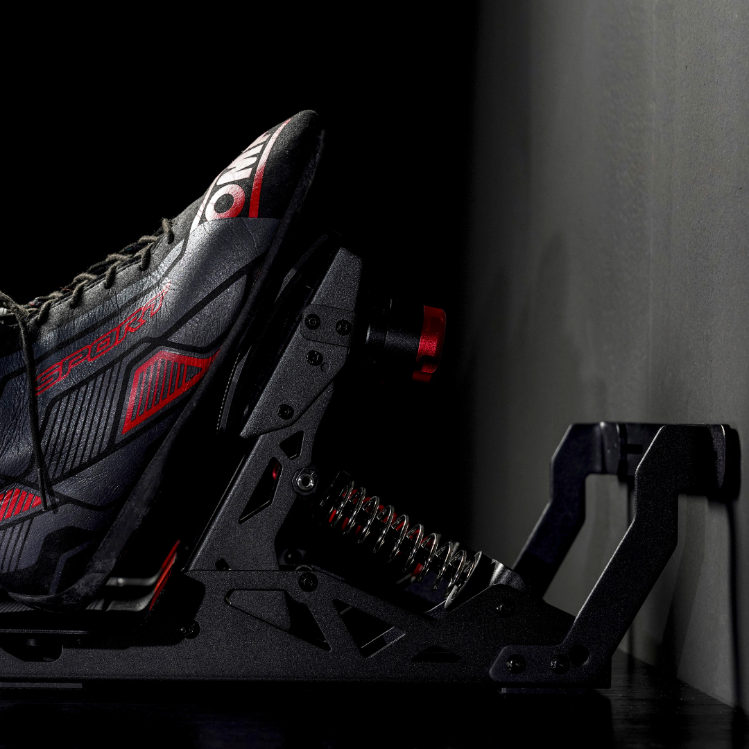 Black and red hockey skate with visible branding on a dark background