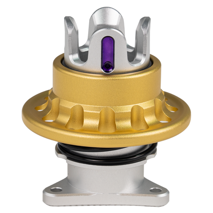 Metallic mechanical component with gold, silver, and purple colors on a white background