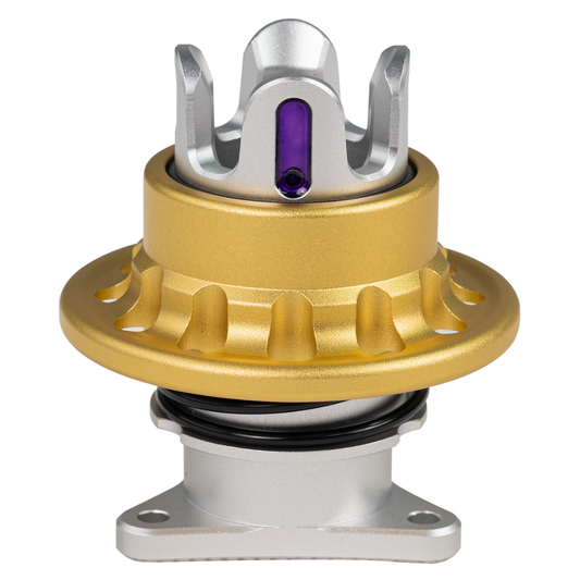 Metallic mechanical component with gold, silver, and purple colors on a white background