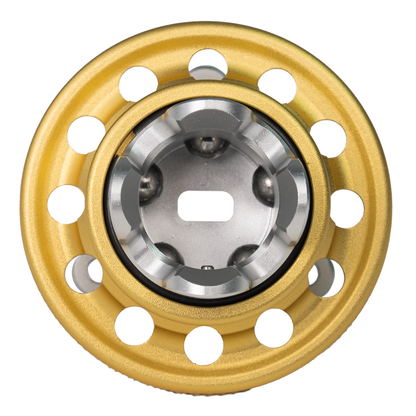 Gold metal wheel hub with silver center on a white background