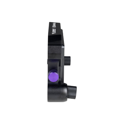 Black mechanical component with a purple button on a white background