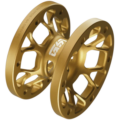 Two gold metal spools on a white background