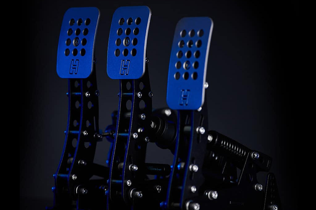 Heusinkveld load cell sim racing pedal set displayed with blue accent lighting