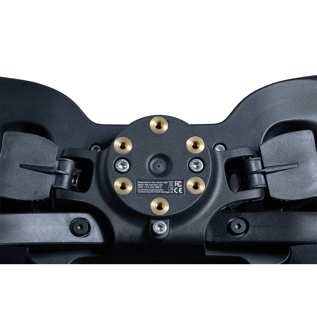 Close-up of a black snowshoe with gold screws on a white background
