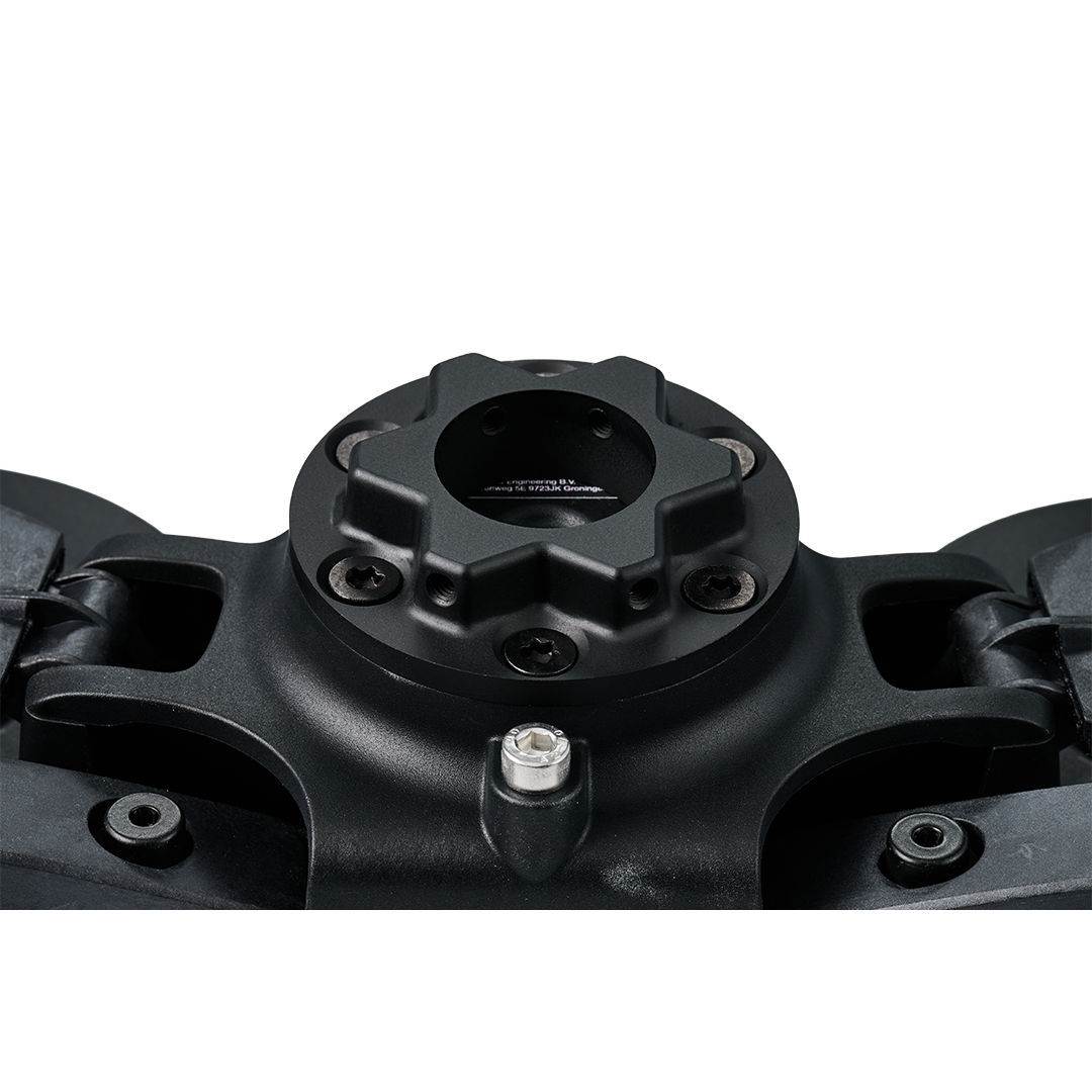 Close-up of a black mechanical component on a white background
