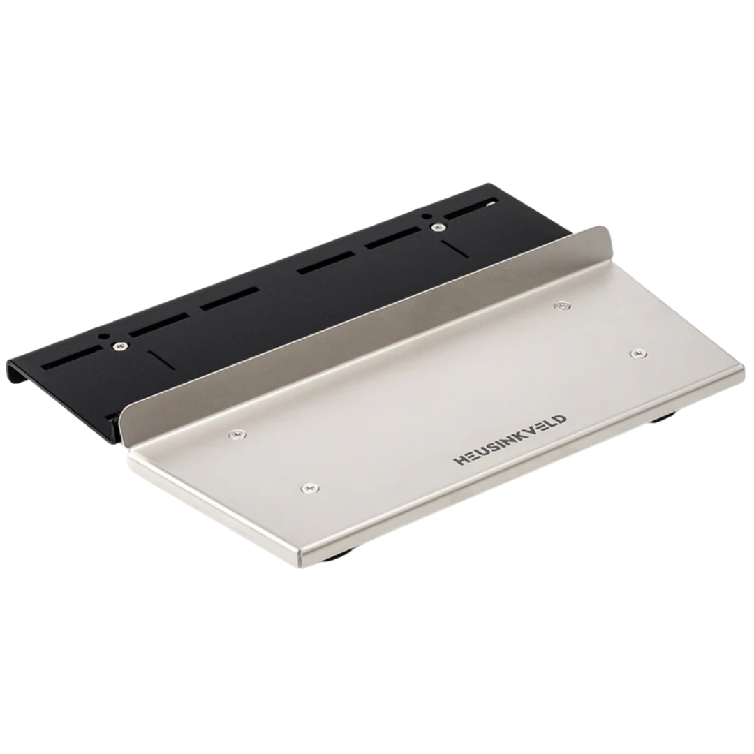A silver and black Heusinkveld baseplate for mounting Sprint pedals, featuring a rigid mounting platform with an adjustable heel plate.