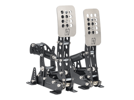 Mechanical racing pedal set with metal pedals and black metal housing on a green background