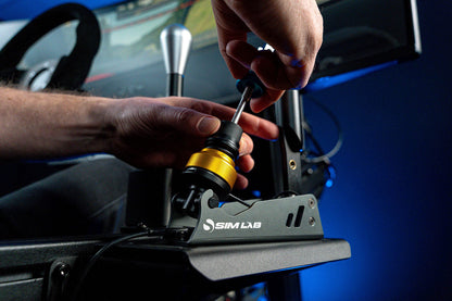 Person adjusting a steering wheel on a Sim Lab simulator