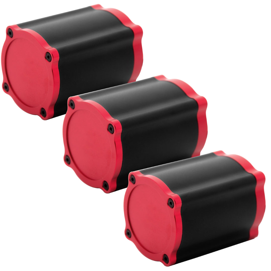 A Simagic Haptic Pedal Reactor with a cylindrical black and red body, accompanied by a power supply and cables.