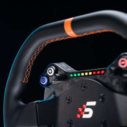 Close-up of a racing steering wheel with brand logo on a black background
