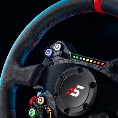 Close-up of a steering wheel with colorful buttons and a brand logo on a black background
