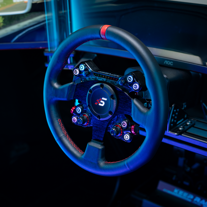 Close-up of a car steering wheel with illuminated buttons and a logo, inside a vehicle.