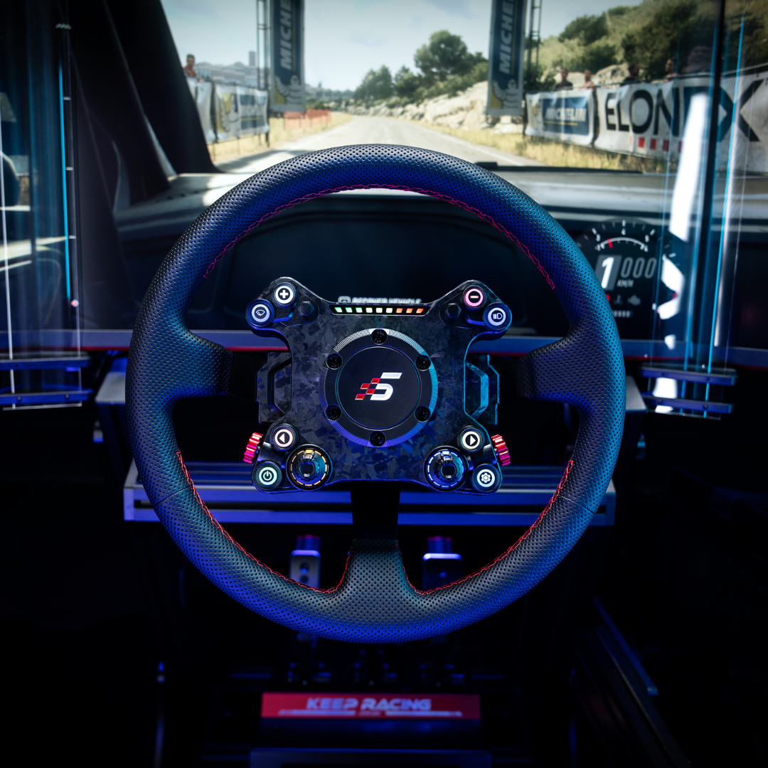 Steering wheel with a logo in a car interior, likely on a race track.