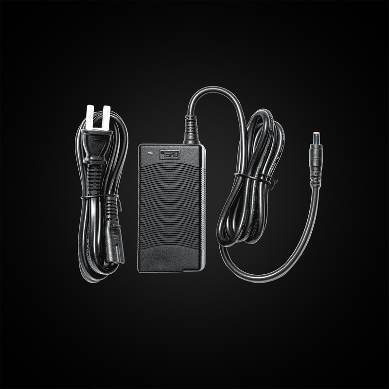 Black power adapter with cables on a black background