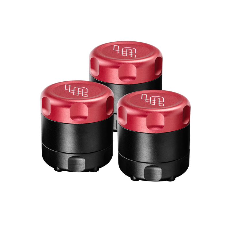 Three black containers with red lids on a white background