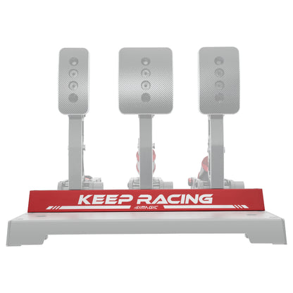 Simagic Heel Stop P1000 Pedals, featuring three inverted silver pedals mounted on a grey base with a red 'KEEP RACING' label.