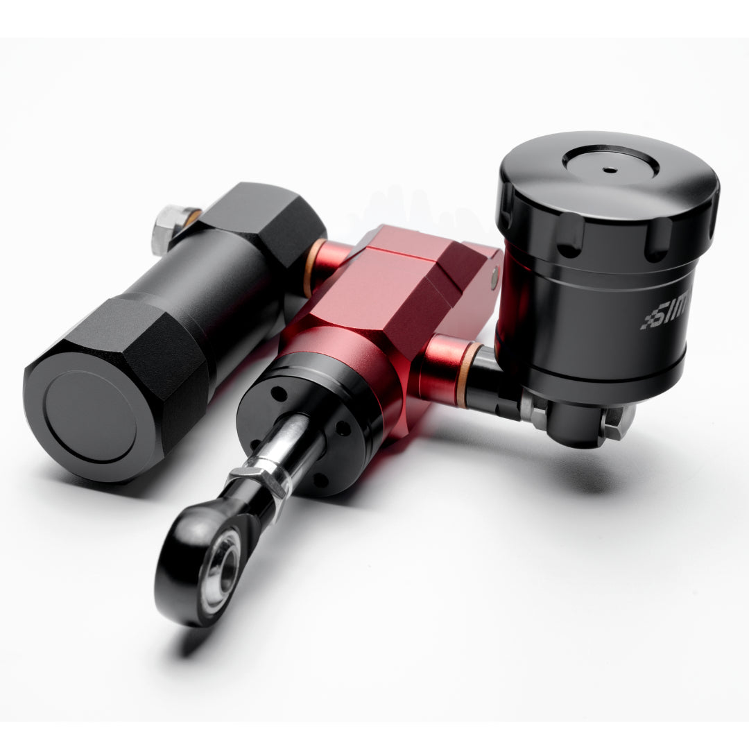 A hydraulic upgrade kit consisting of a black and red pedal and a black hydraulic cylinder, likely made of metal and plastic components.