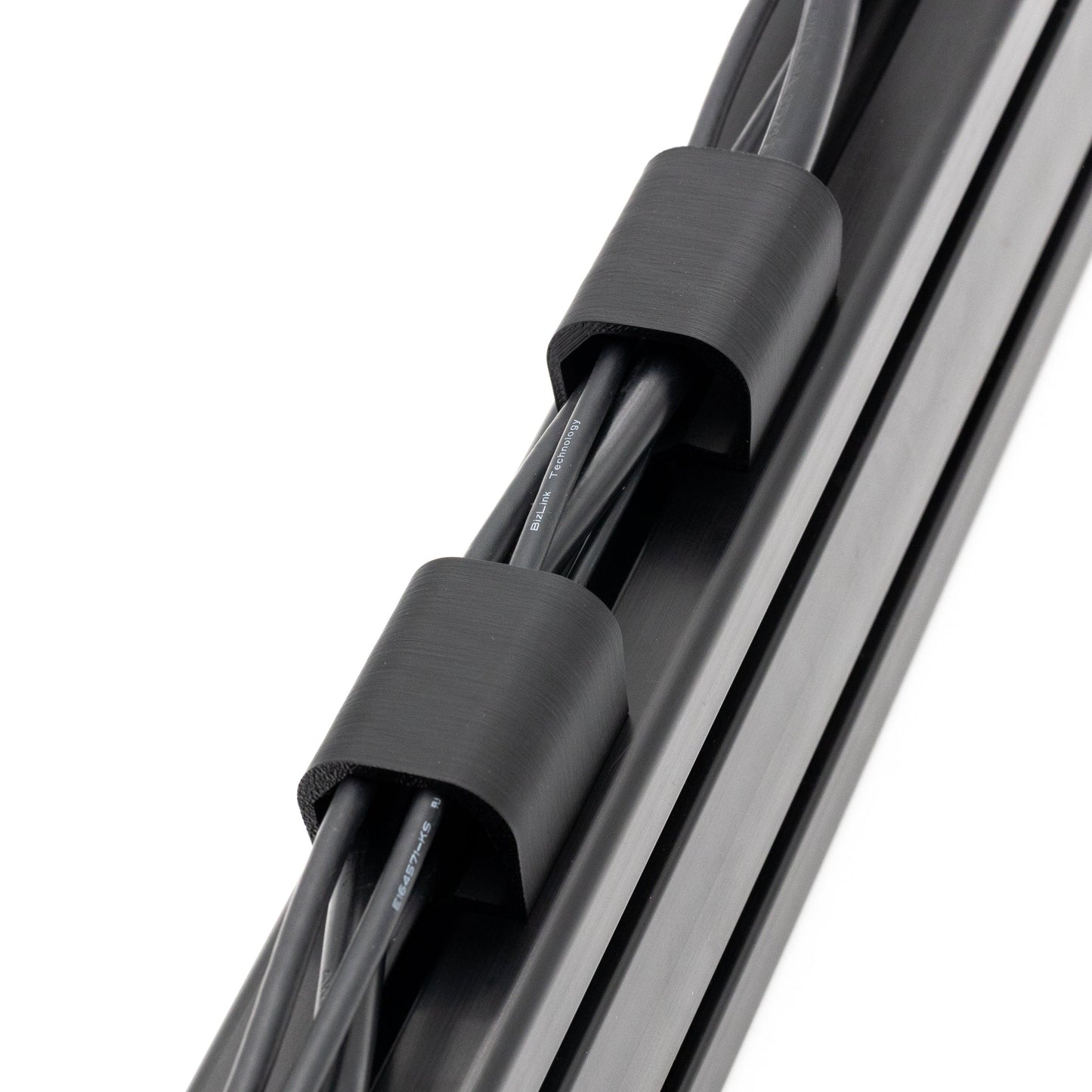 Close-up of a cable with black connectors on a white background