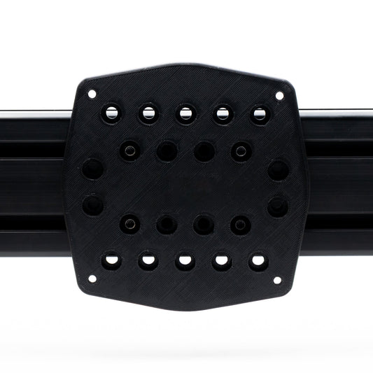 Black rubber mat with multiple holes on a white background