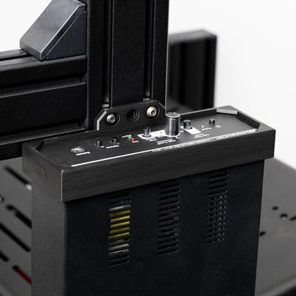 Close-up of a black electronic device with control panel and buttons on a blurred background