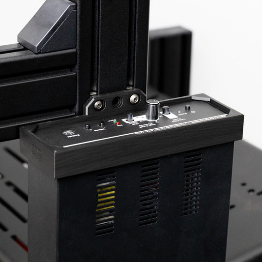 Close-up of a black electronic device with control panel and buttons on a blurred background