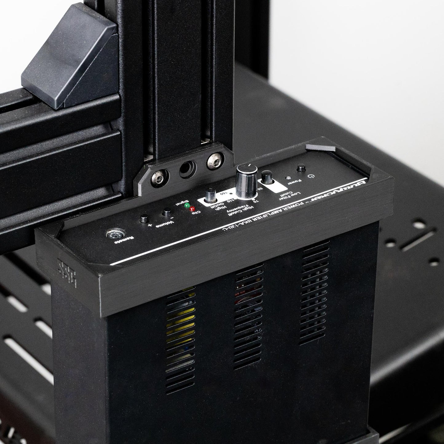 Close-up of a 3D printer's control panel and mechanical components.