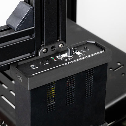 Close-up of a 3D printer's control panel and mechanical components.