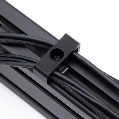 Close-up of a black metal cable management system on a white background