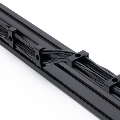 Black cable management tray with cables on a white background