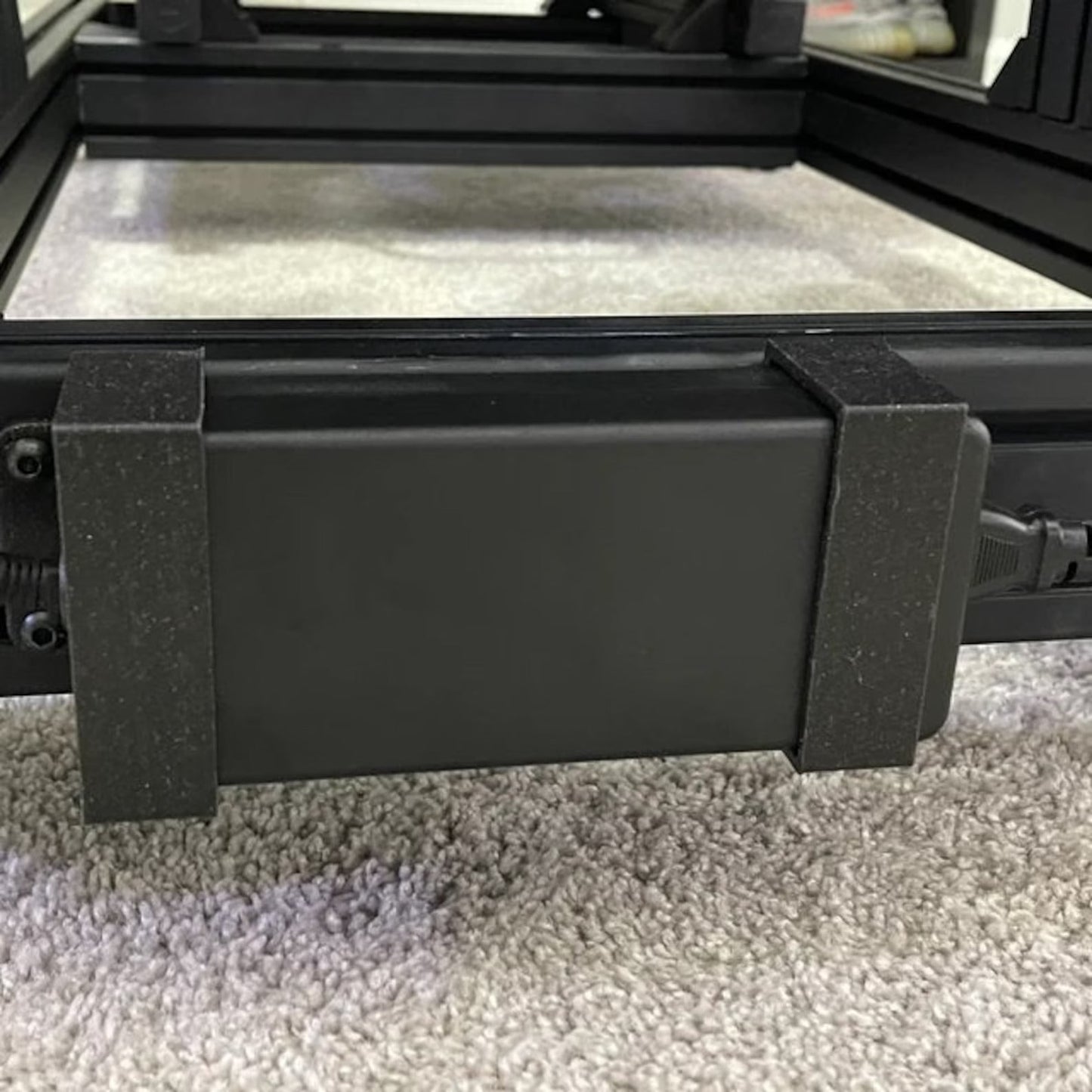 Black rectangular object on a carpeted floor