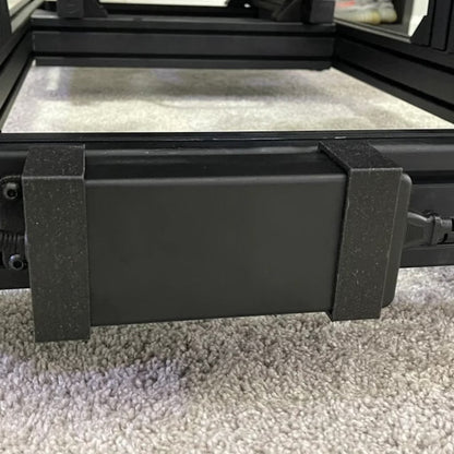Black rectangular object on a carpeted floor