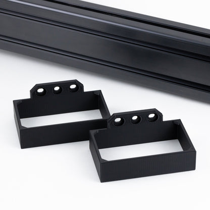Two black metal brackets on a white background