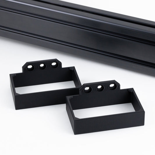 Two black metal brackets on a white background