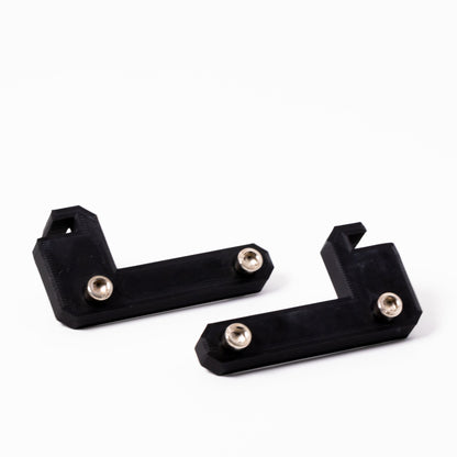 Two black metal brackets with screws on a white background