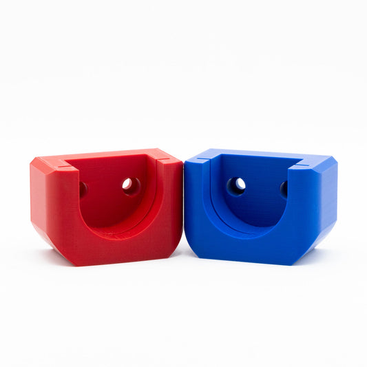 Red and blue plastic wall hooks on a white background