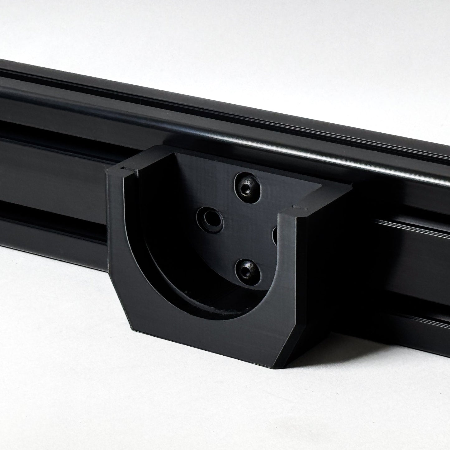 Close-up of a black metal roof rack on a white background