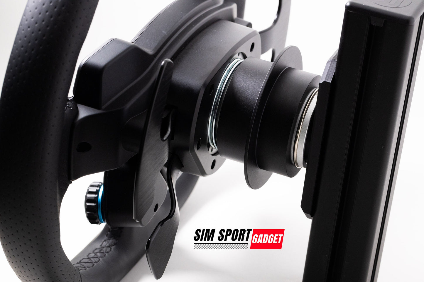 Close-up of a black steering wheel and monitor setup with 'Sim Sport Gadget' branding.