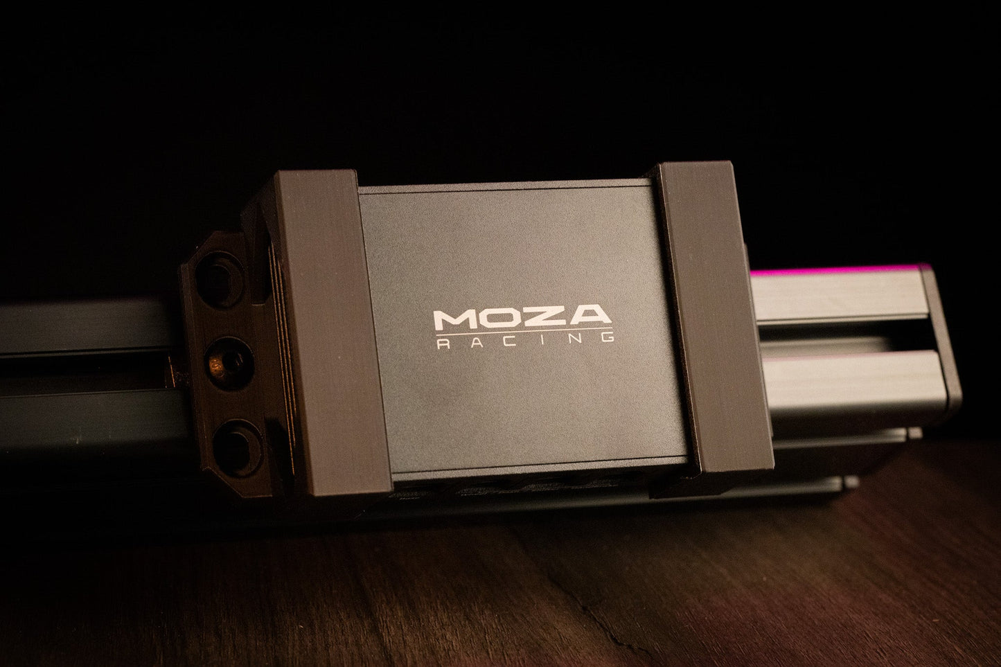MOZA Racing camera mount on a wooden surface with a dark background