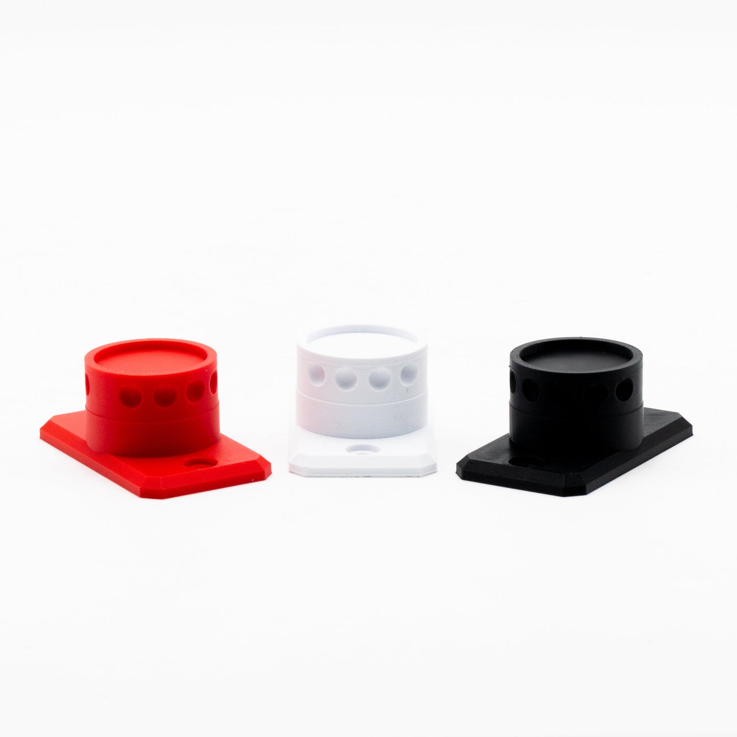 Three silicone cup holders in red, white, and black on a white background