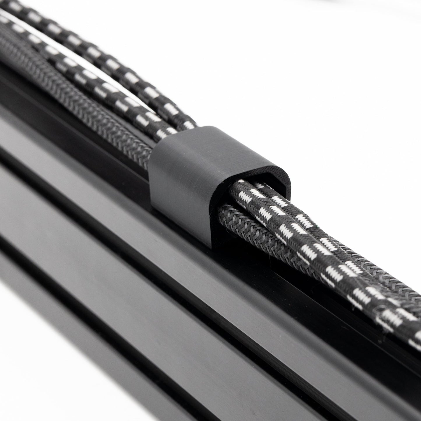 Close-up of a metal rod with a textured black and gray rope缠绕在上面