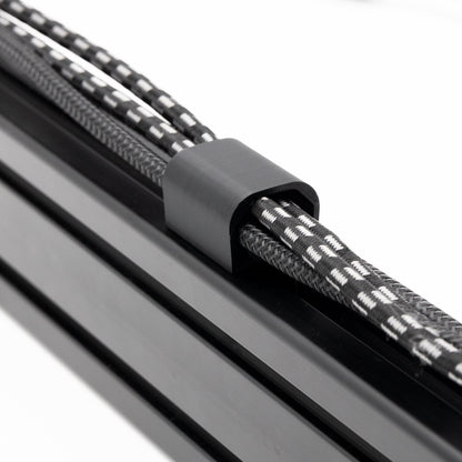 Close-up of a metal rod with a textured black and gray rope缠绕在上面