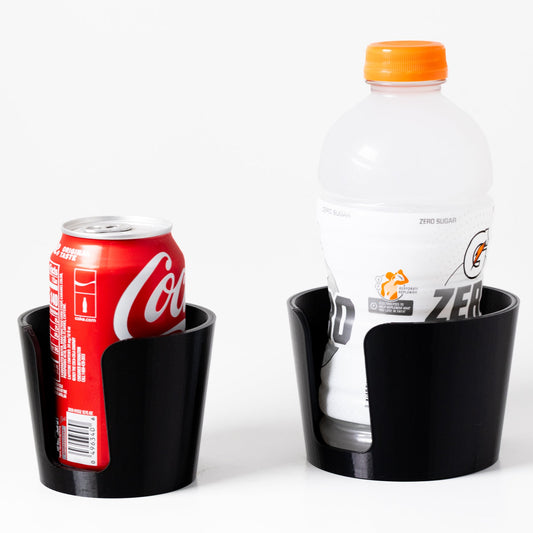 Black drink holder with Coca-Cola can and Diet Coke bottle on a white background