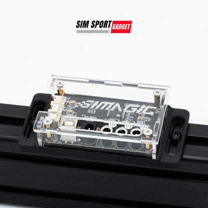 Electronic module with 'SIMAGIC' branding on a white background, featuring the SIM Sport Gadget logo.