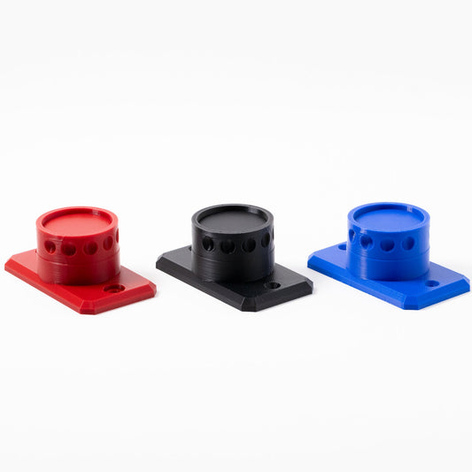 Three cylindrical plastic holders in red, black, and blue on a white background