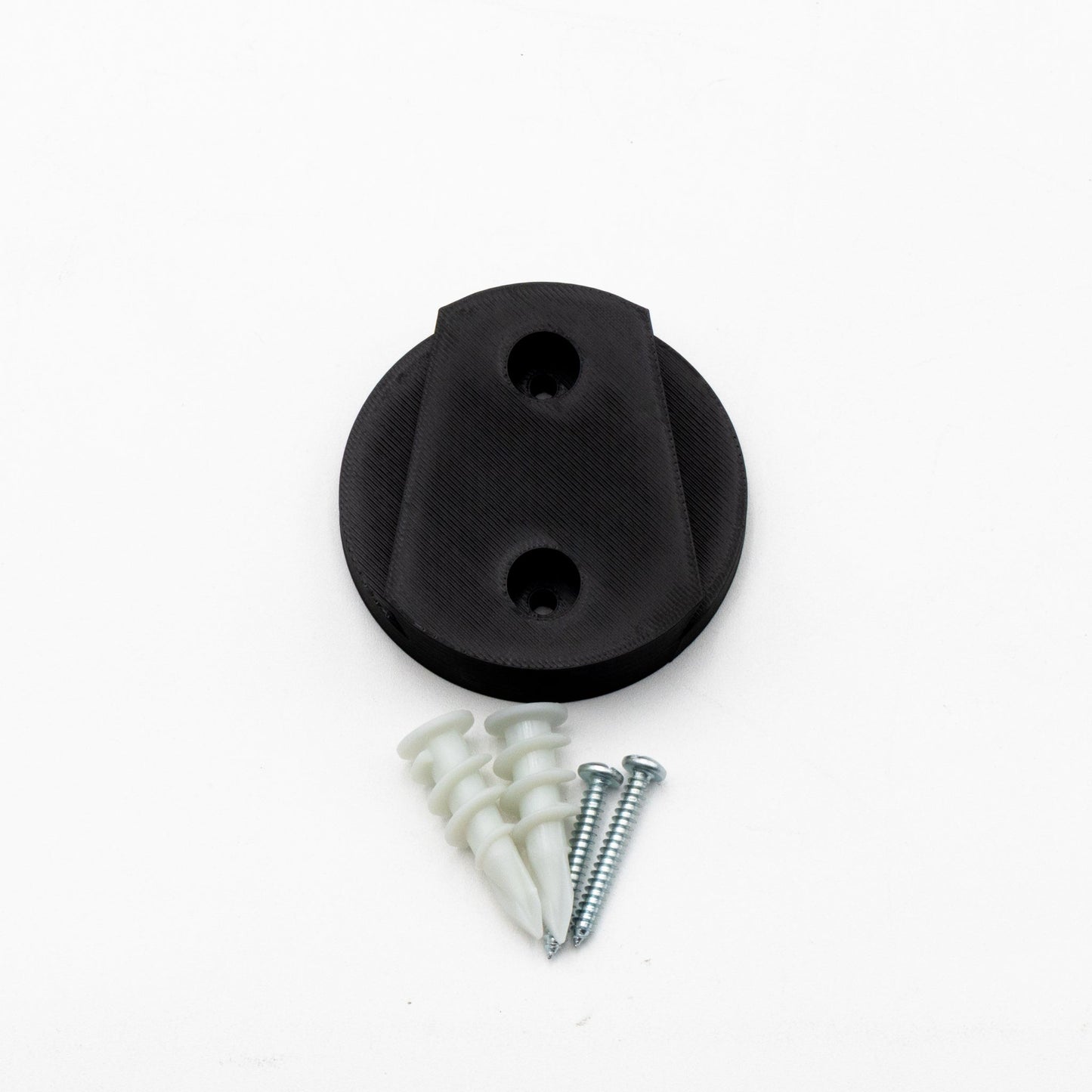 Black rubber stopper with screws and washers on a white background