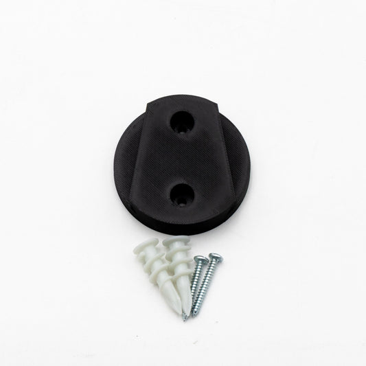 Black rubber stopper with screws and washers on a white background