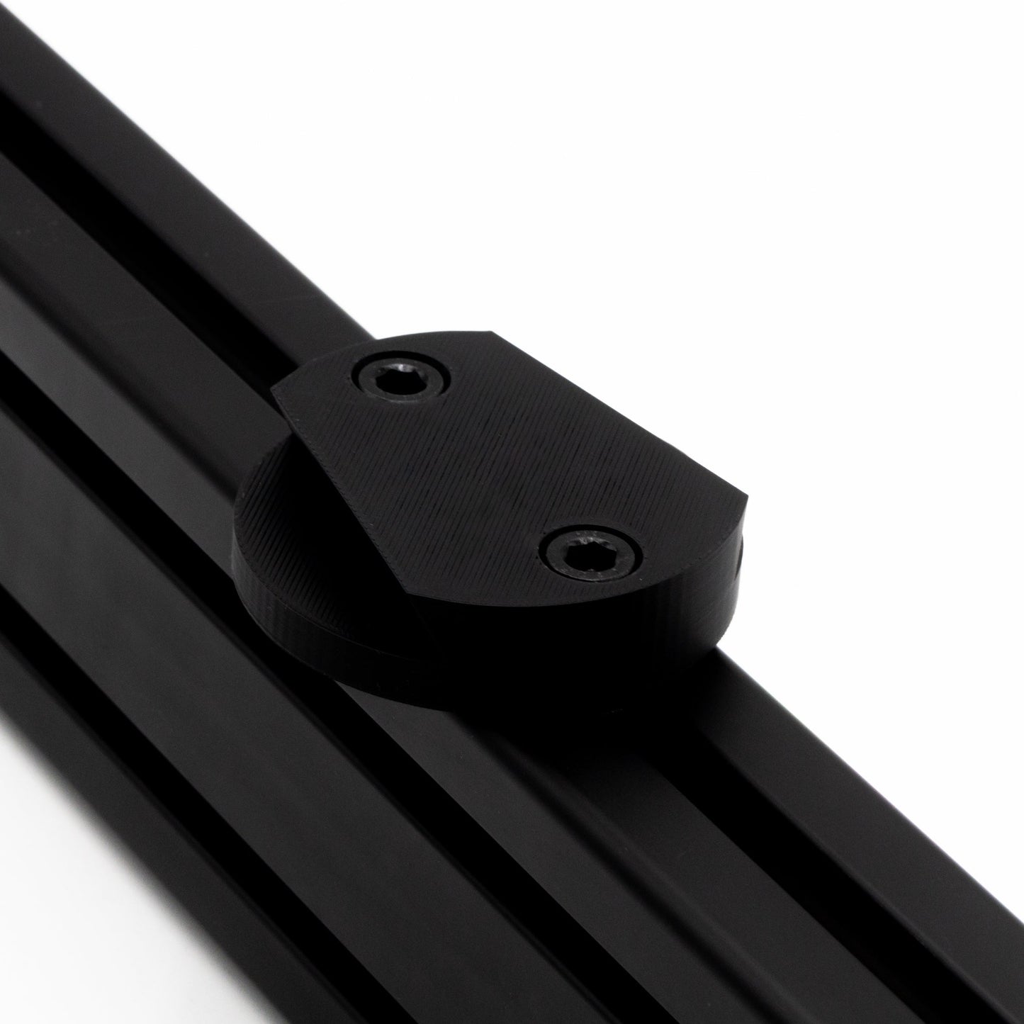 Close-up of a black metal rod with a clamping mechanism on a white background