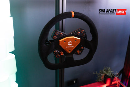Black and orange gaming steering wheel with a brand logo on a gray background