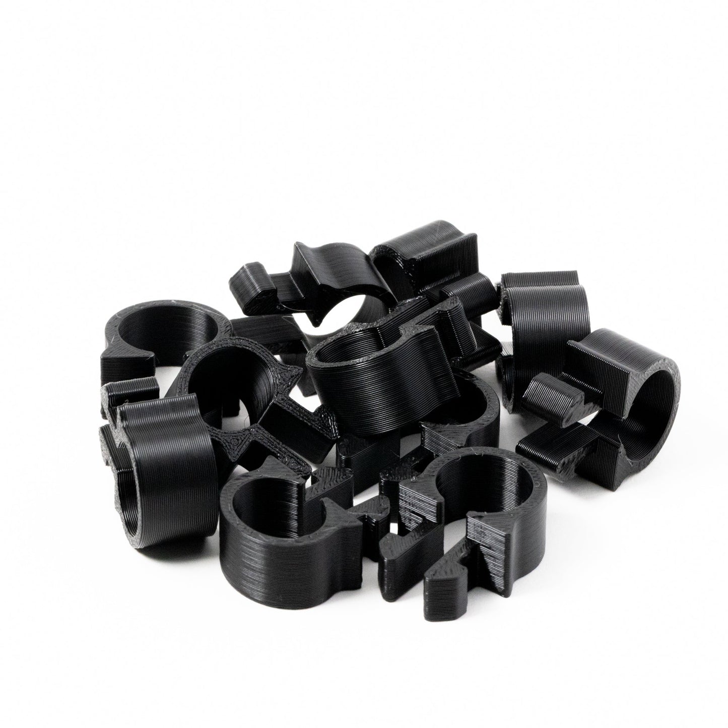 Collection of black metal clips on a white background