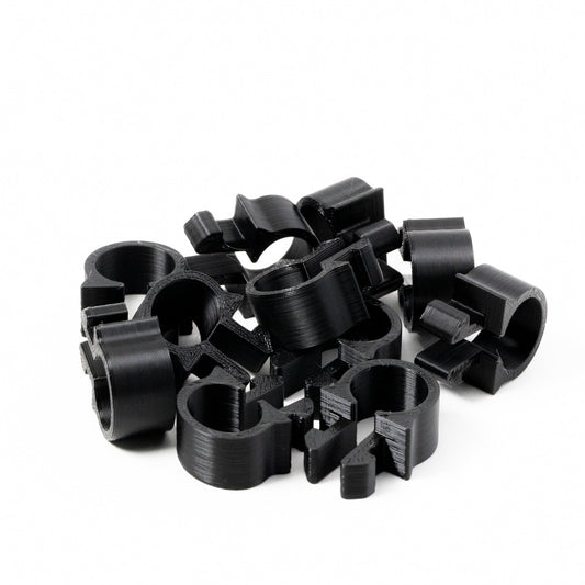 Collection of black metal clips on a white background